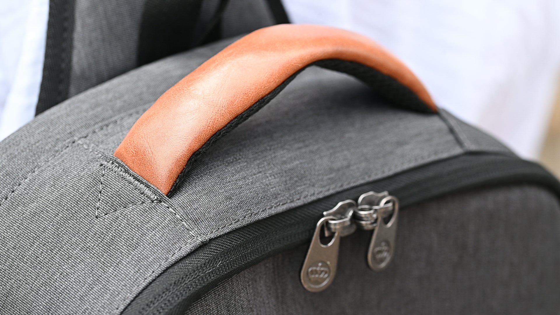 PKG Robson 12L Cross-Body Laptop Bag top view showing lockable zippers and vegan leather handle