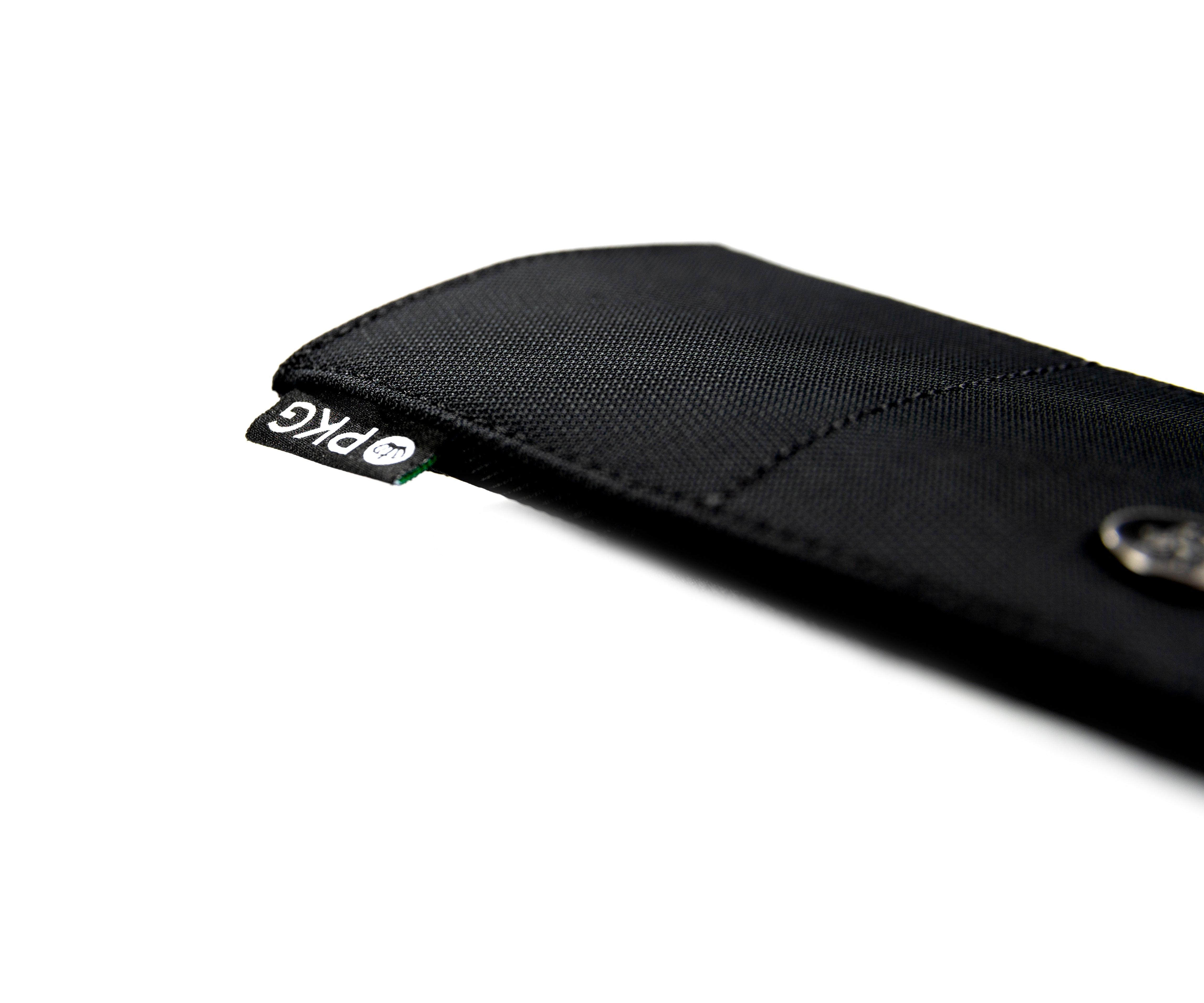 PKG Perry RFID Passport Wallet (black) angled view showing durable material details