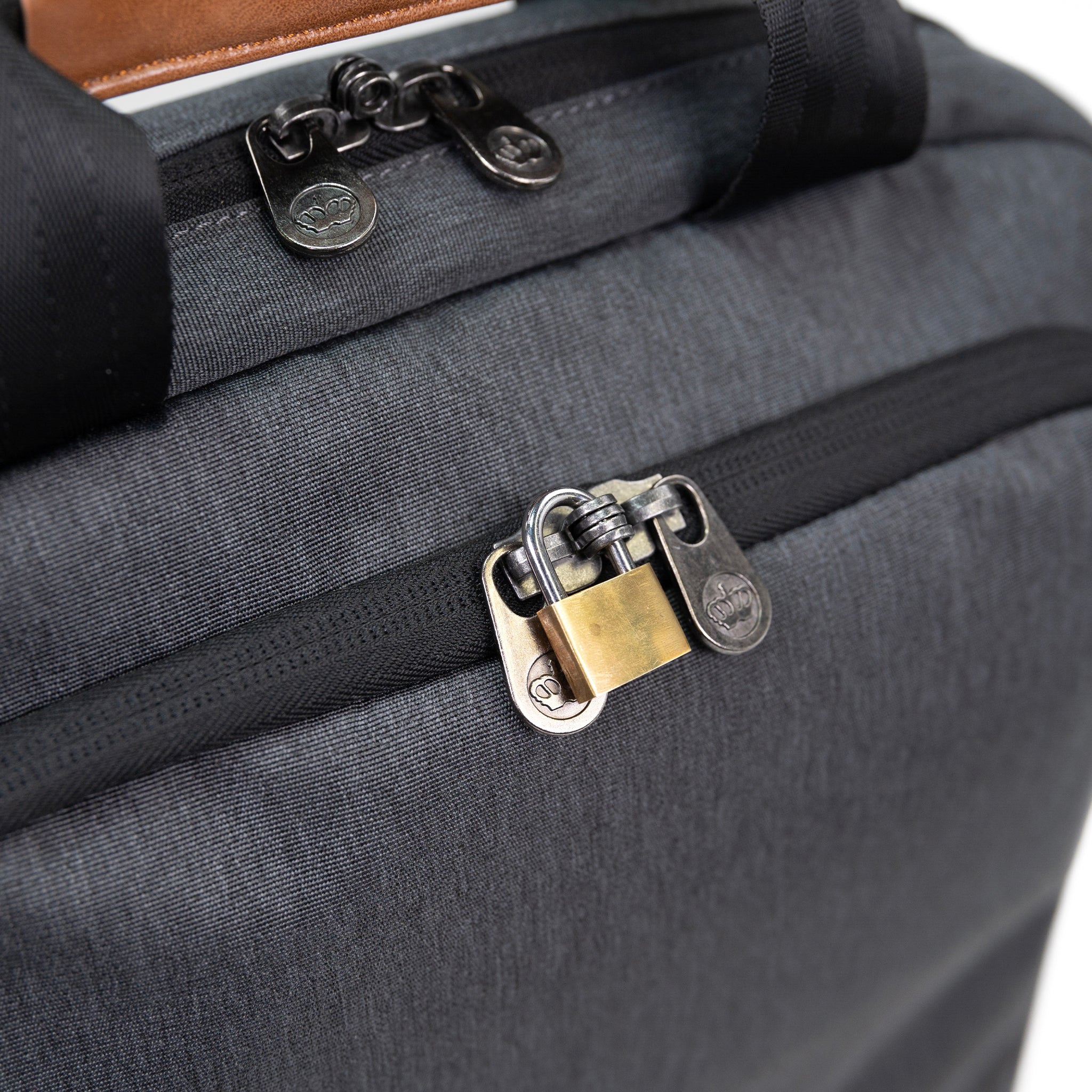 PKG Riverdale 11L Messenger Bag detailed top view of lockable zippers connected with padlock