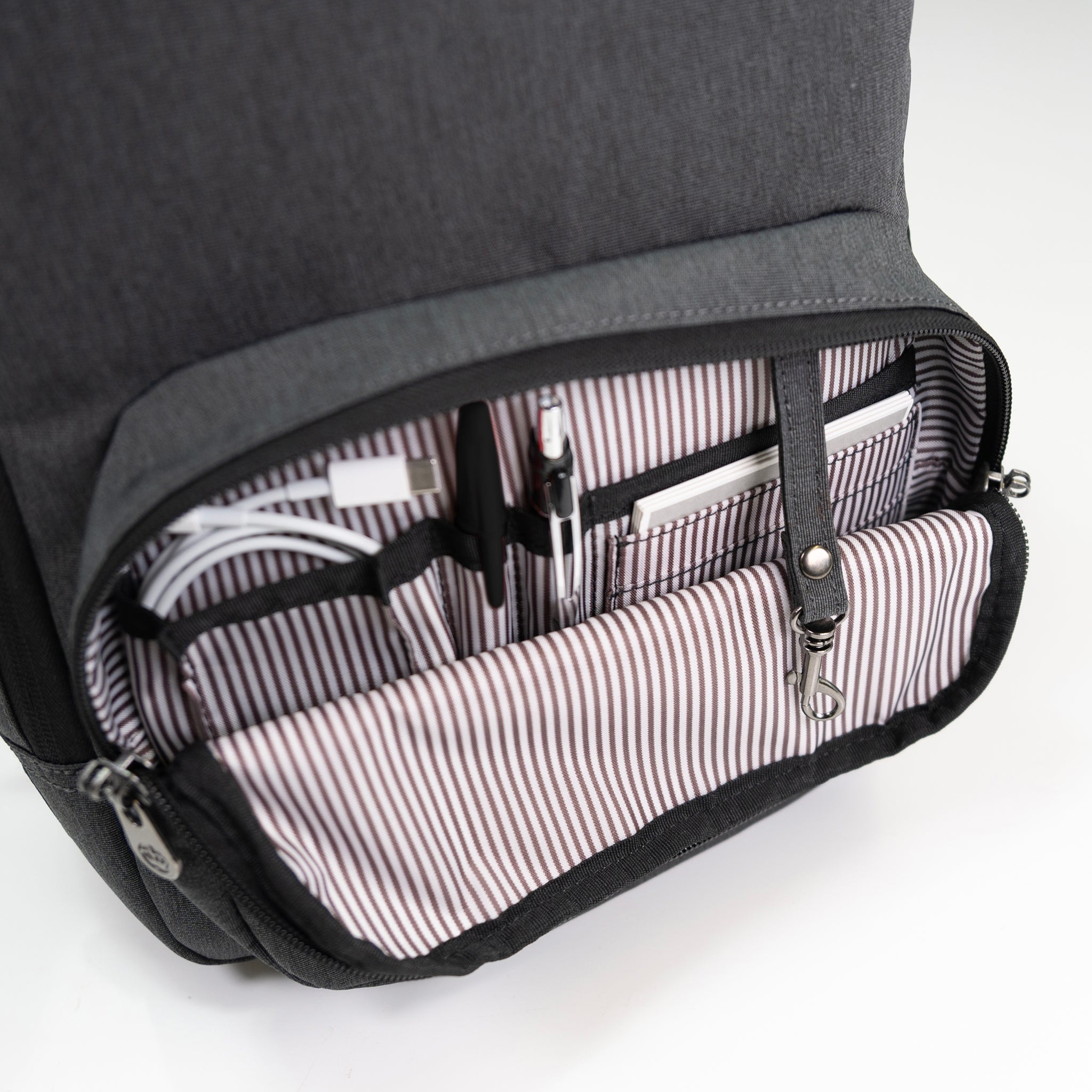 PKG Robson 12L Cross-Body Laptop Bag detailed view of front pocket with built in organization and key ring hook