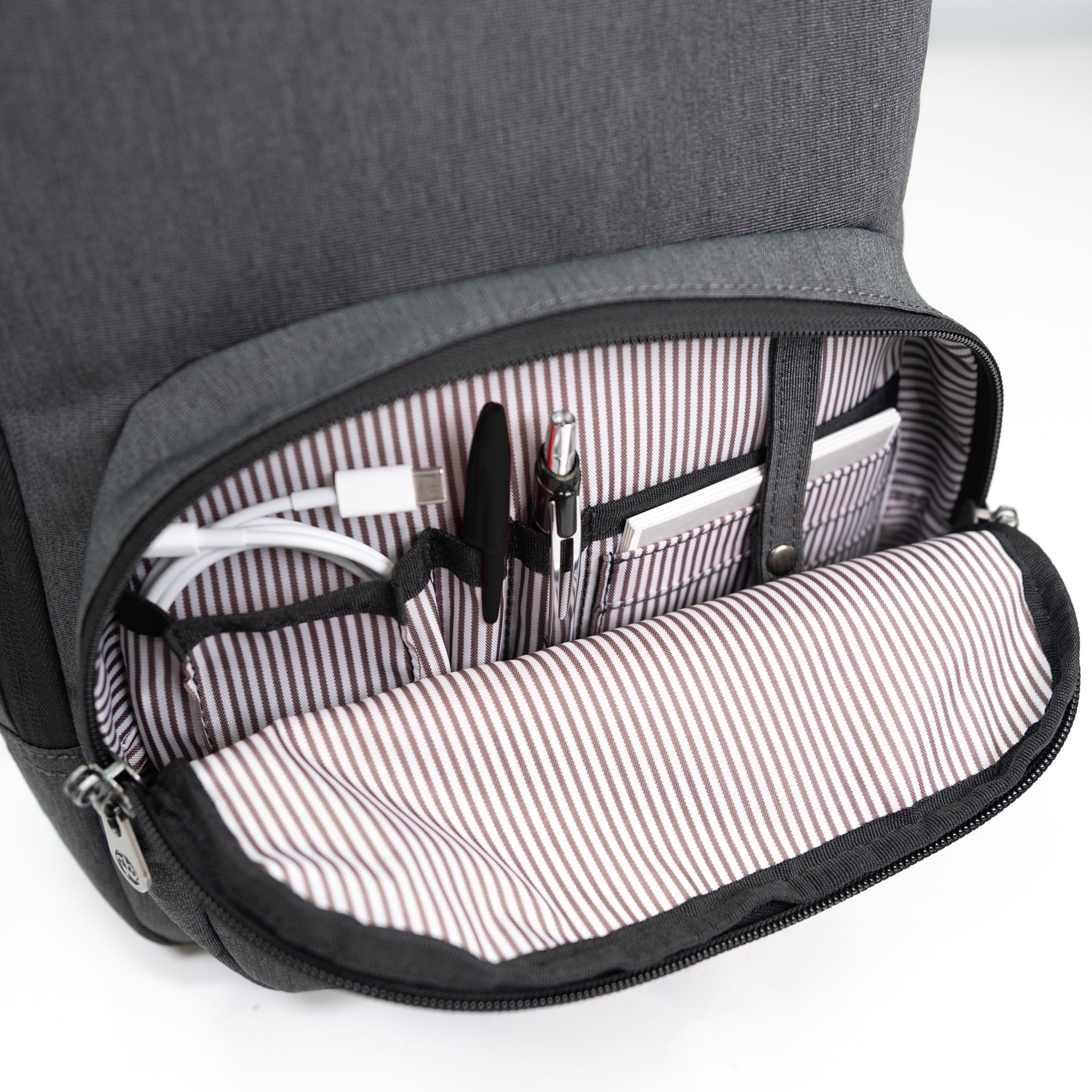 PKG Robson 12L Cross-Body Laptop Bag detailed view of front pocket with built in organization and key ring hook