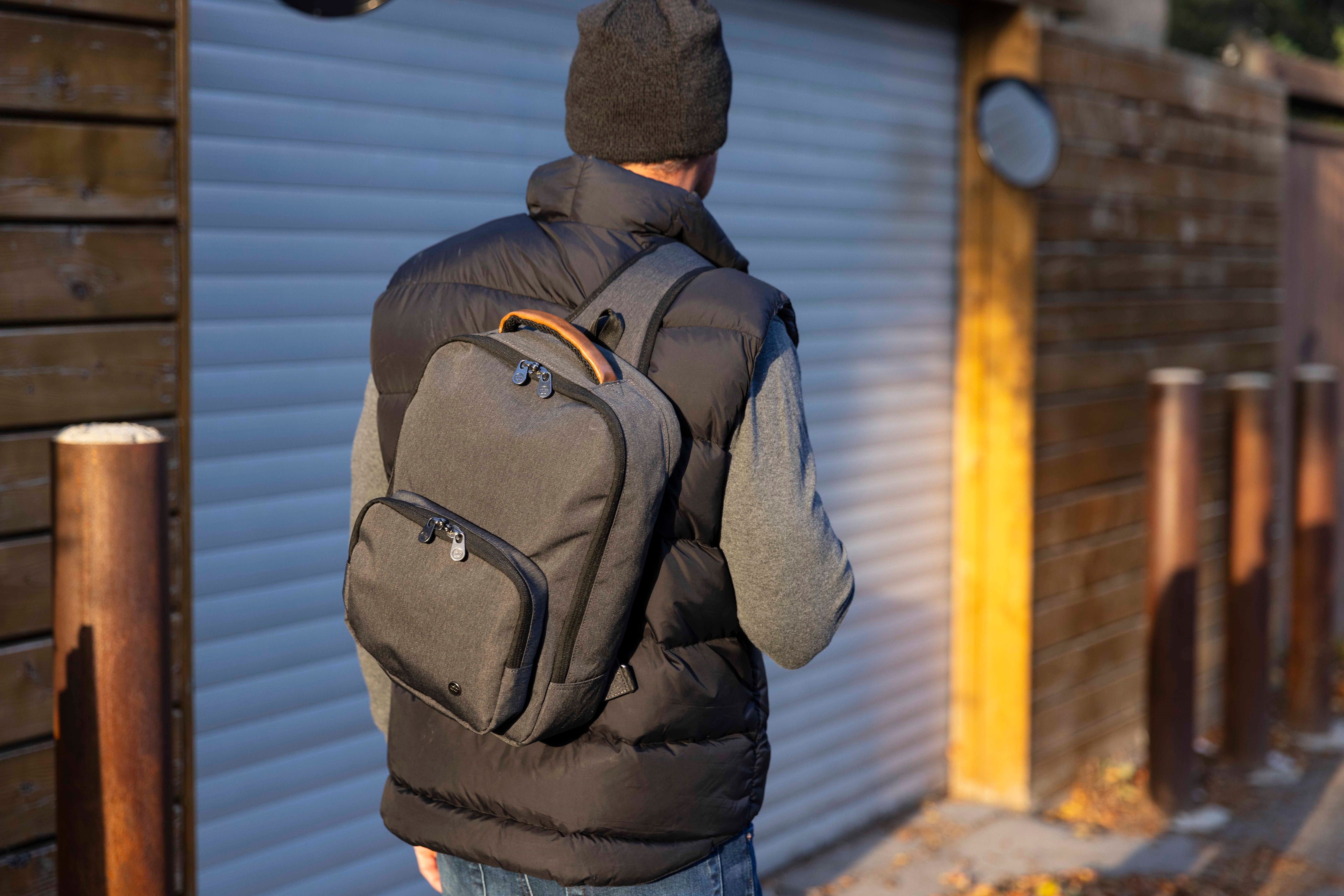 Man carrying PKG Robson 12L Cross-Body Laptop Bag on shoulder