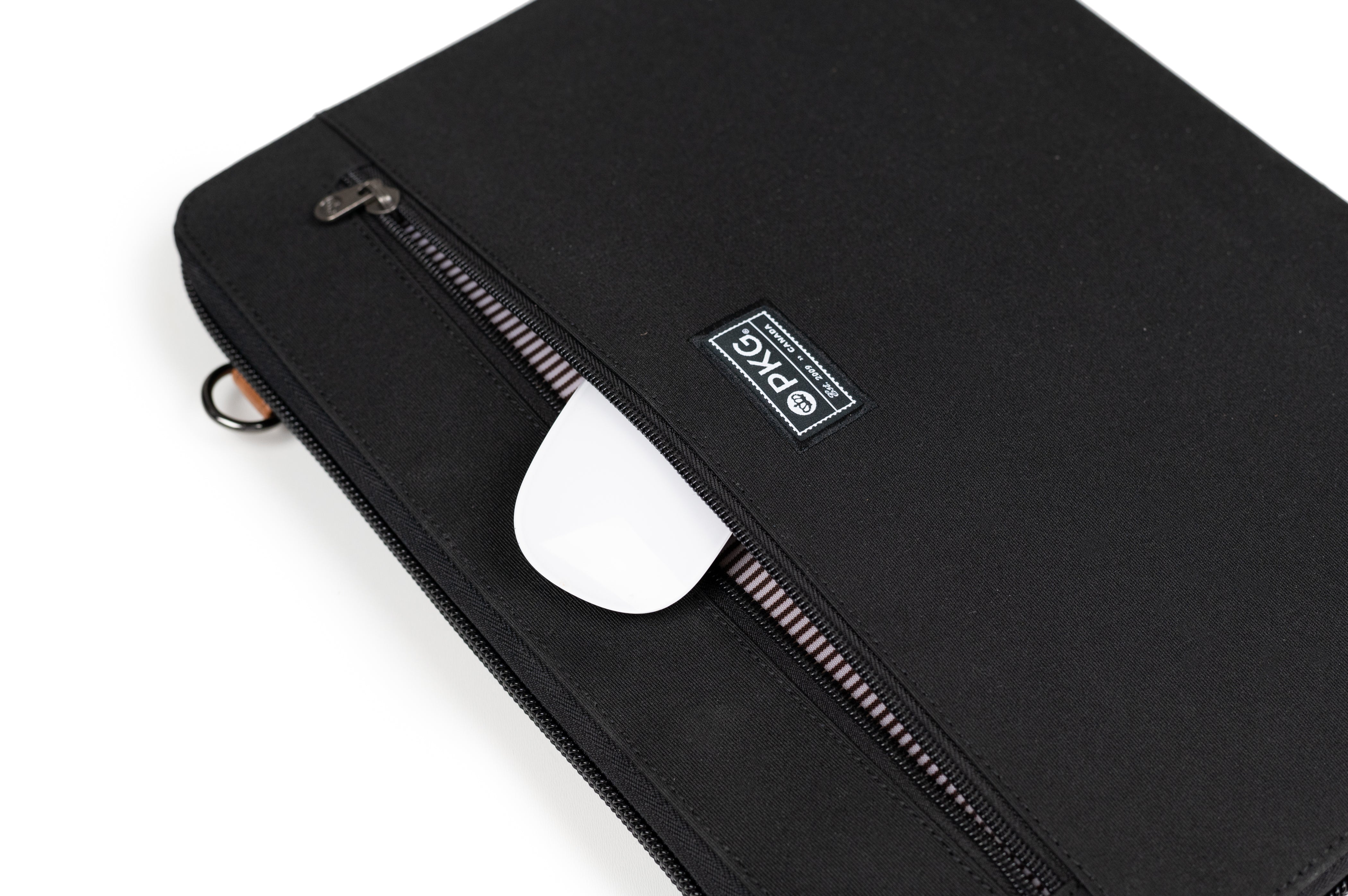 PKG Wellington 10L Messenger (black) showing computer mouse inserted into front outer pocket