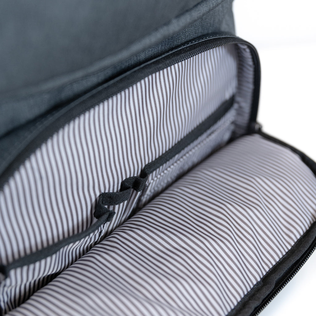PKG Aurora recycled backpack (grey) showing inside of small accessory pocket with organization slots