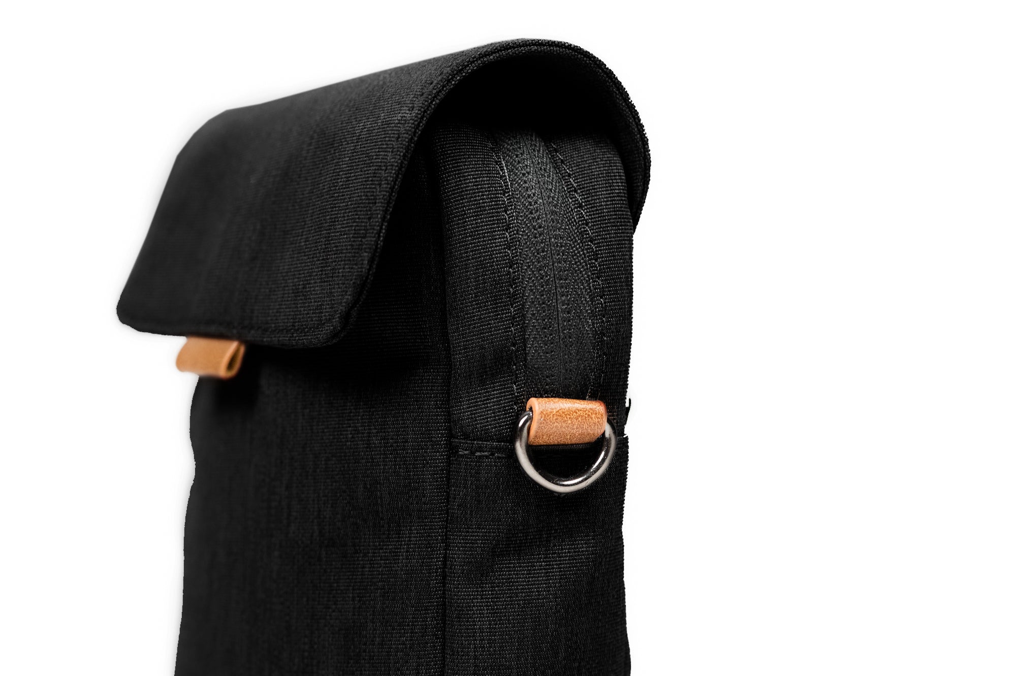 PKG Burrard recycled cross body bag (black), side view showing d-ring for attachable shoulder strap