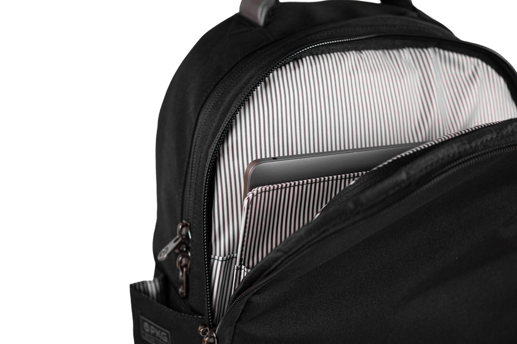 PKG Durham Commuter 17L recycled backpack (black) showing dedicated laptop pocket with secure velcro strap