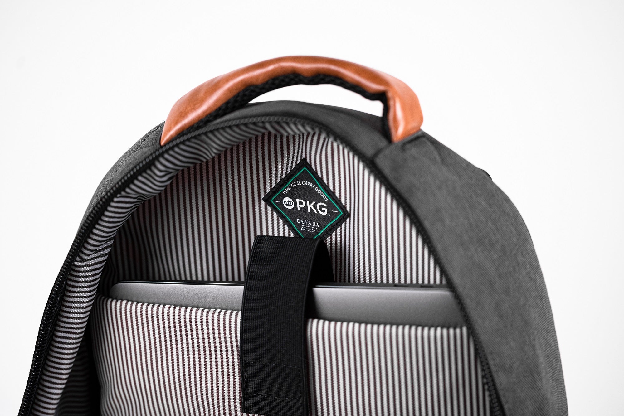 PKG Durham Commuter 17L recycled backpack (dark grey) showing dedicated laptop pocket with secure velcro strap