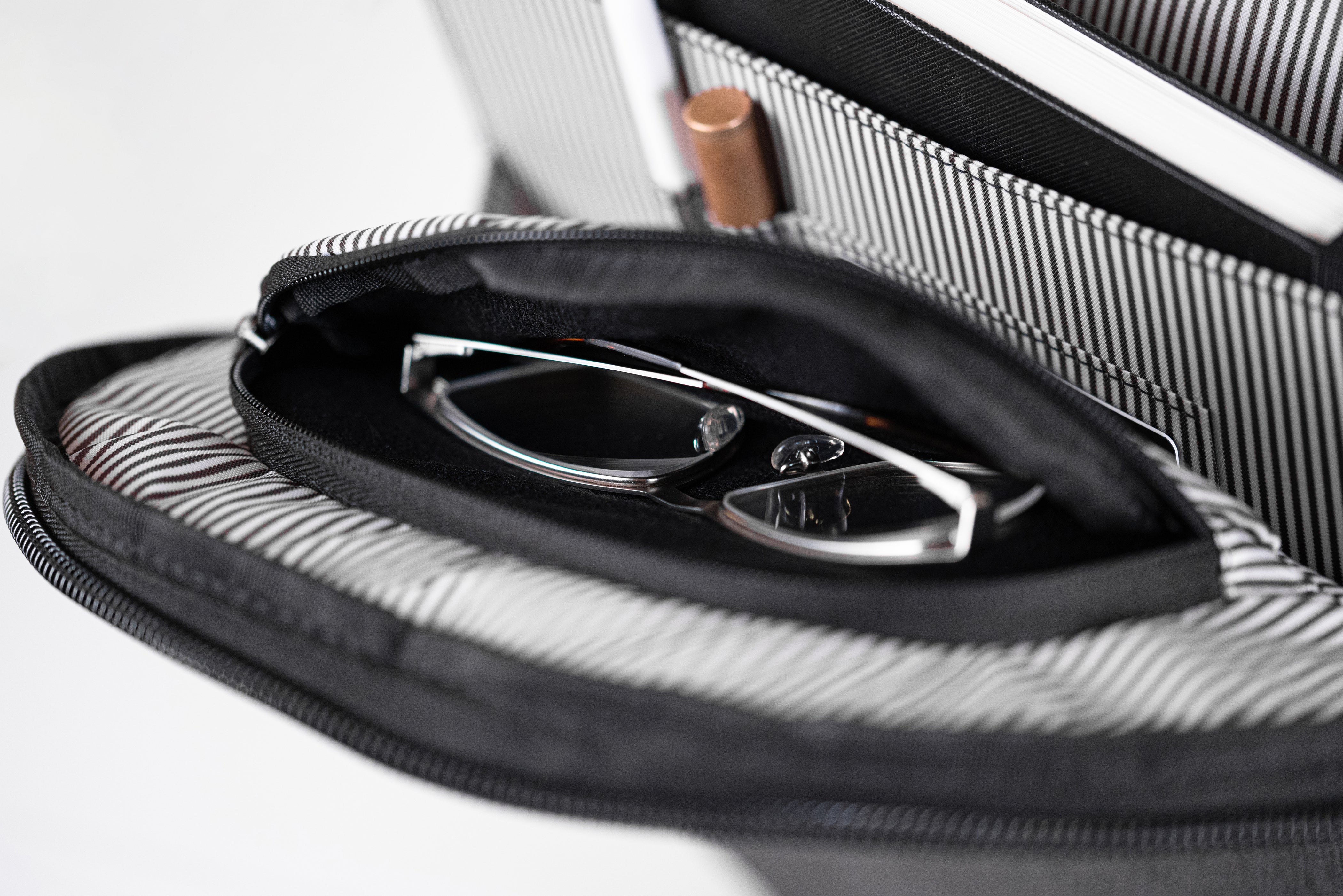 PKG Durham Commuter 17L recycled backpack (dark grey) showing sunglasses compartment