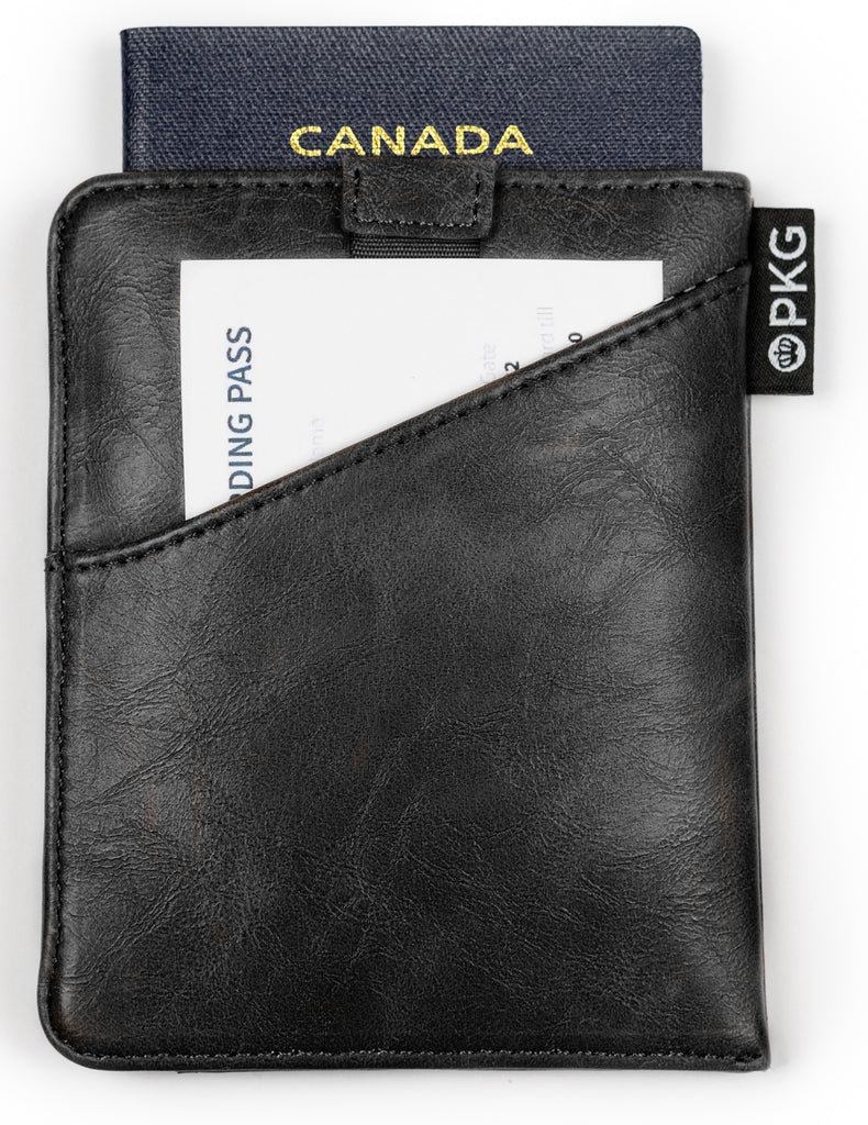 PKG Perry RFID Passport Wallet (black) showing passport inside as well as convenient outer slot for documents such as boarding passes