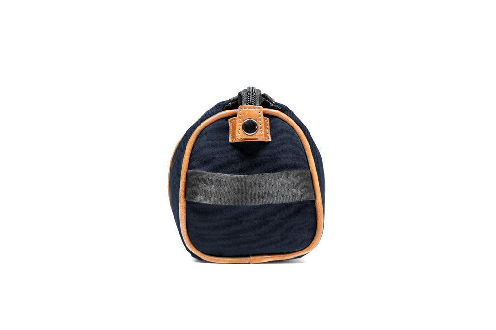  PKG Charlotte Recycled Toiletry Bag (navy) side view showing strap