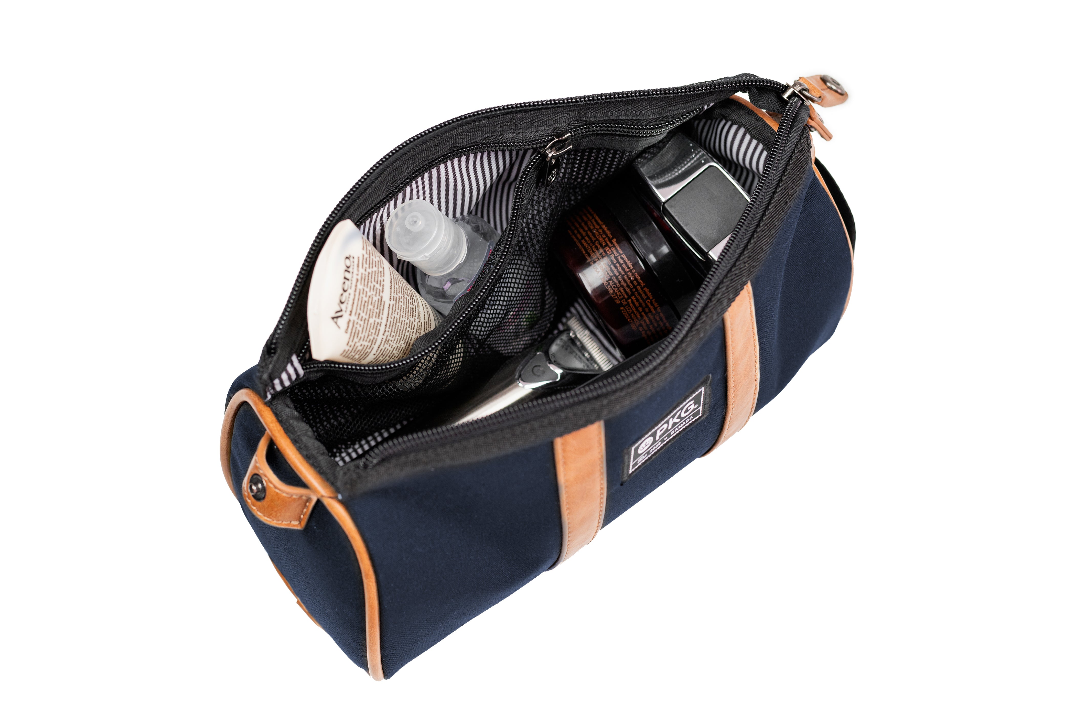 PKG Charlotte Recycled Toiletry Bag (navy) top view showing toiletry products inside organized compartments