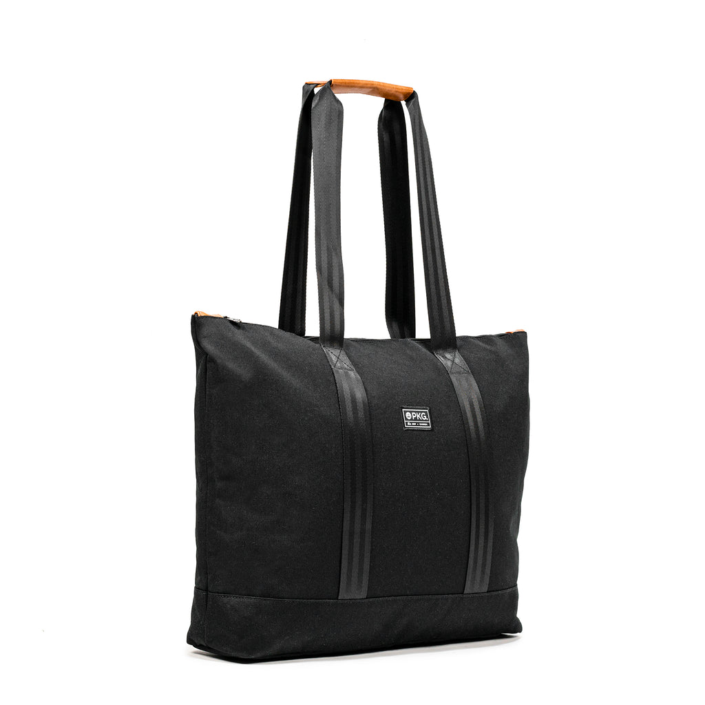 PKG Lawrence 16L Recycled Tote Bag (black). This mid-size tote, made from weather-resistant recycled fabrics, is your ideal everyday carry. With exterior trolley straps, it's perfect for women's purse essentials or a laptop bag