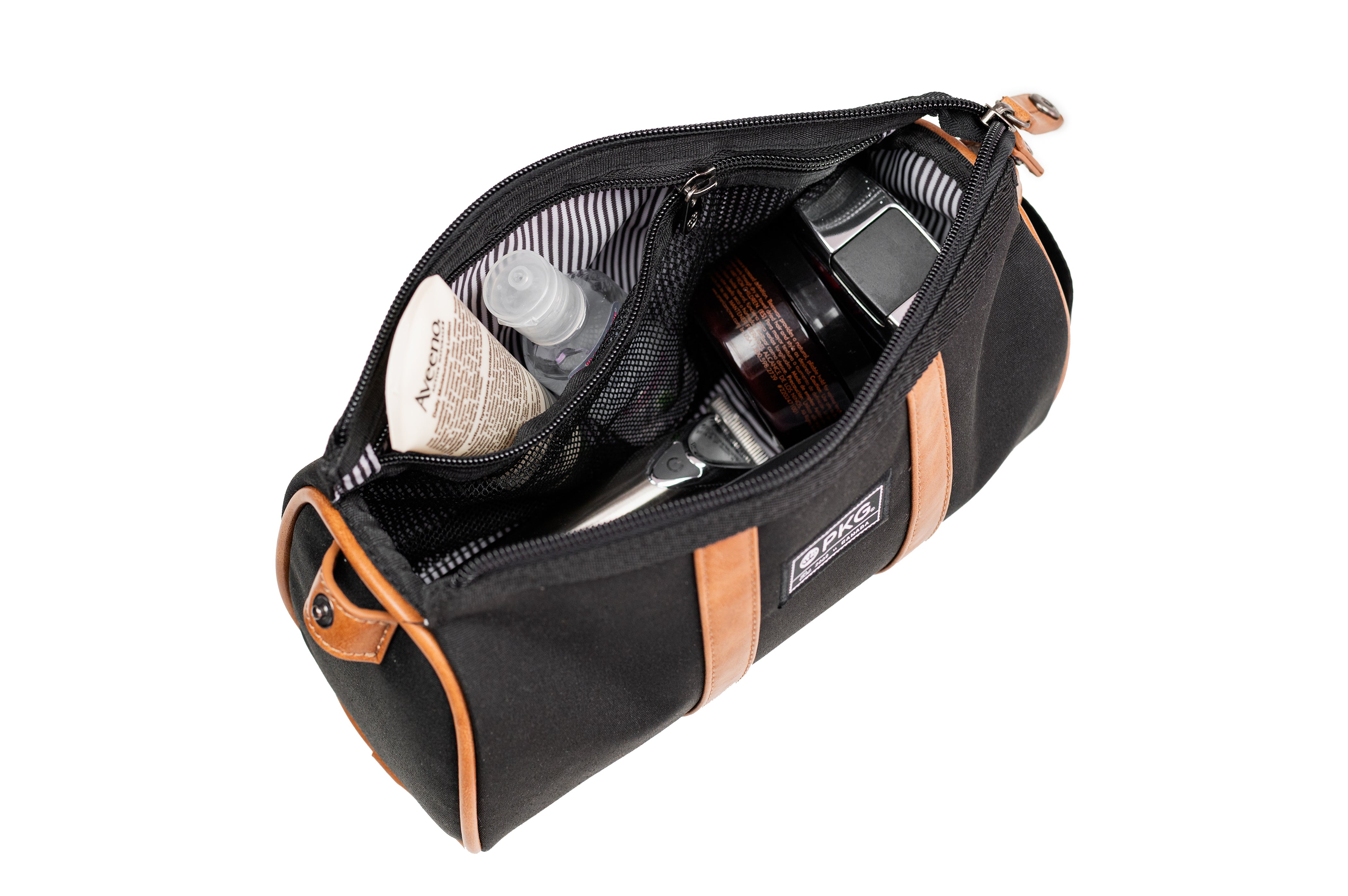 PKG Charlotte Recycled Toiletry Bag (black) top view showing toiletry products inside organized compartments