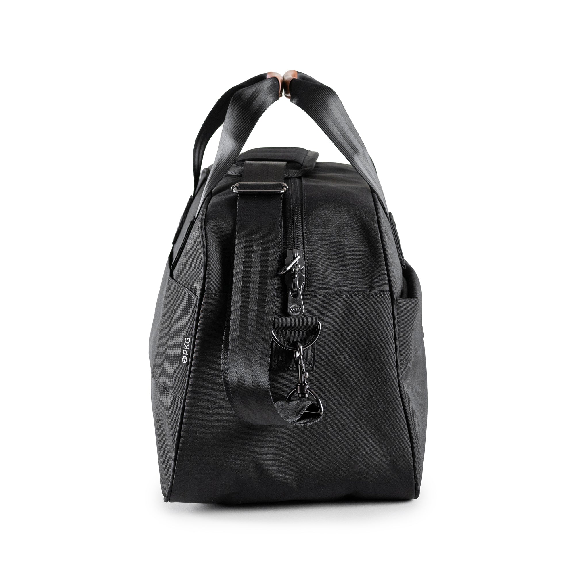 PKG Westmount 26L Recycled Duffle Bag (black) side view showing d-ring connected to detachable shoulder strap