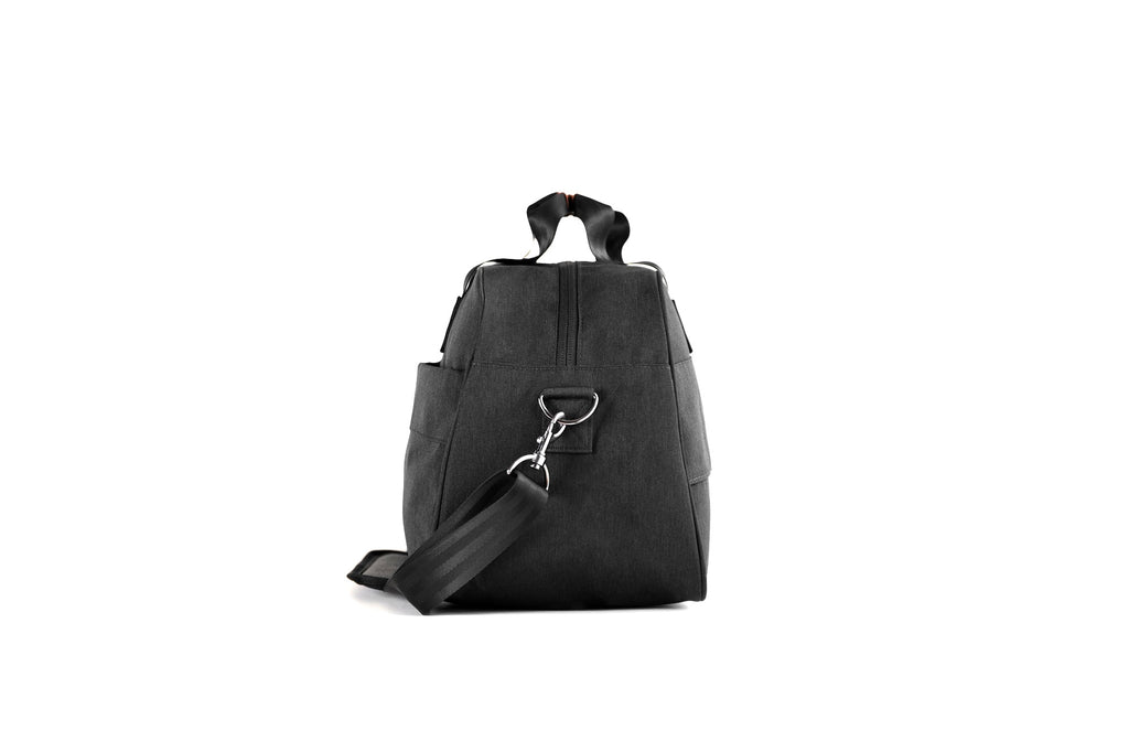 PKG Westmount 26L Recycled Duffle Bag (black) side view showing d-ring connected to detachable shoulder strap