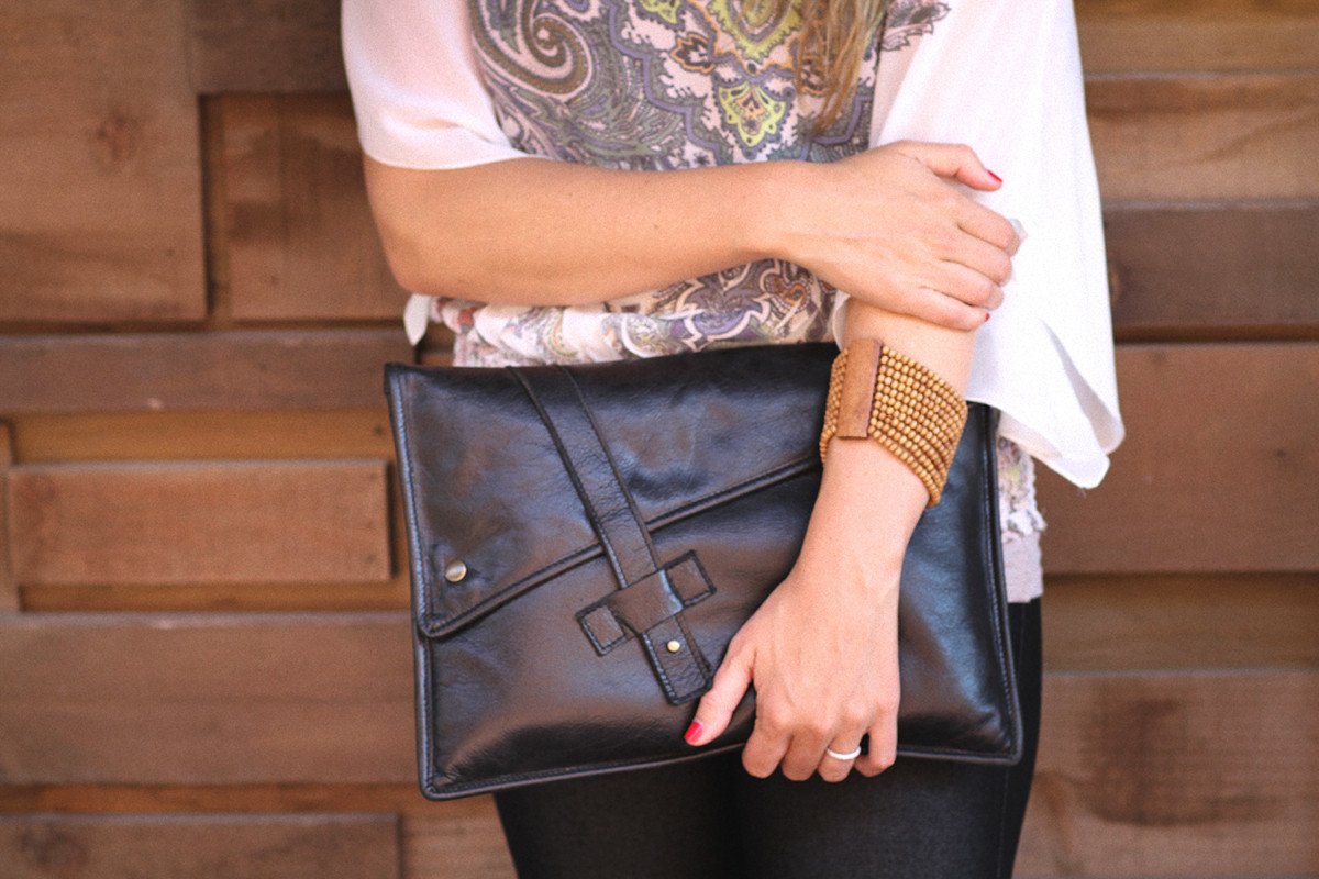 person holding PKG Slim Leather Sleeve 13" (black)