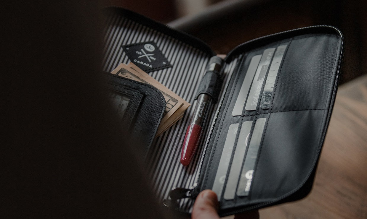 Victoria RFID Clutch Wallet (tan) open, showing various cards, money, and pen stored inside dedicated compartments