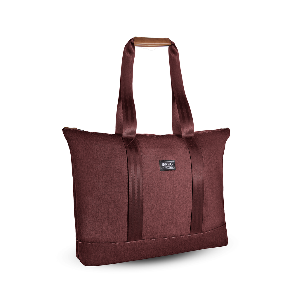 PKG Lawrence 16L Recycled Tote Bag (rum raisin). This mid-size tote, made from weather-resistant recycled fabrics, is your ideal everyday carry. With exterior trolley straps, it's perfect for women's purse essentials or a laptop bag