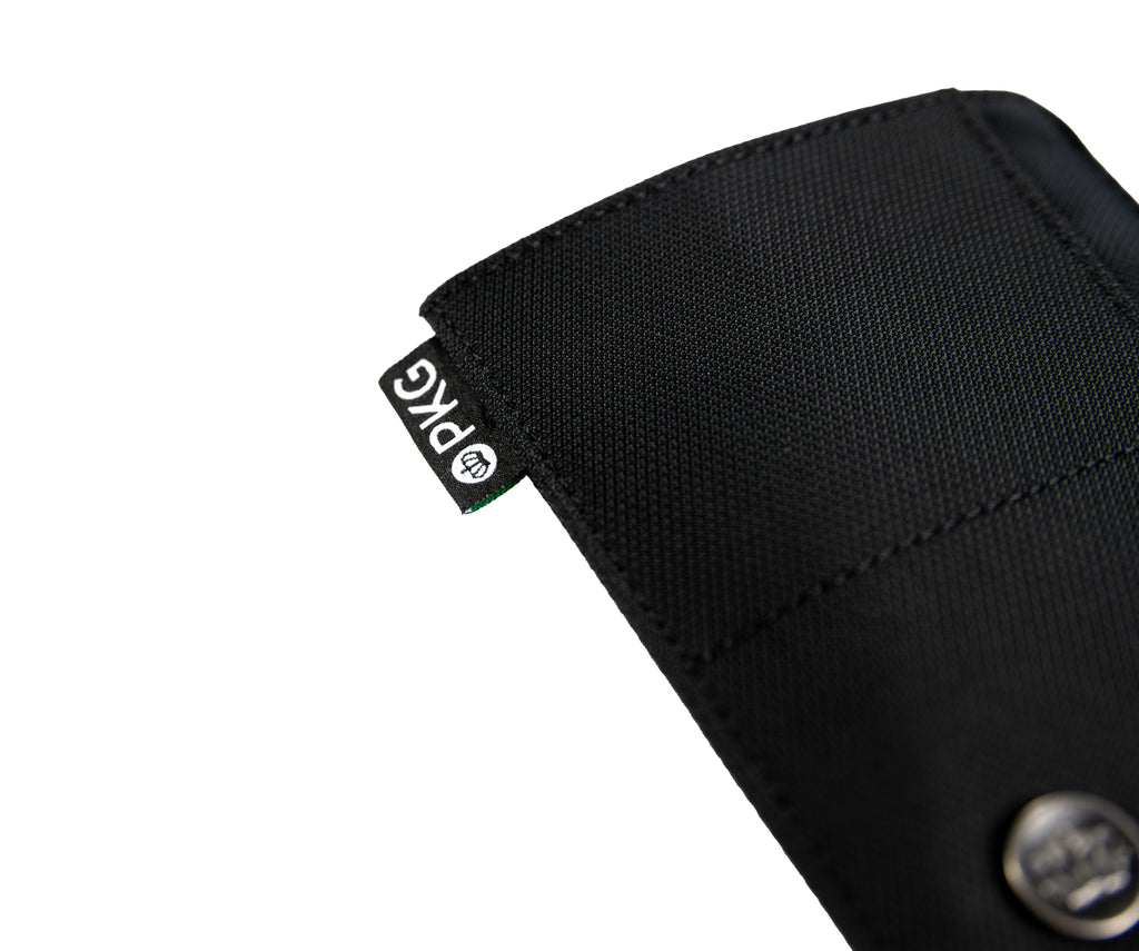 PKG Perry RFID Passport Wallet (black) angled view showing durable material details
