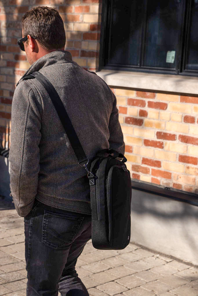 Man walking with PKG Riverdale 11L Messenger Bag on shoulder