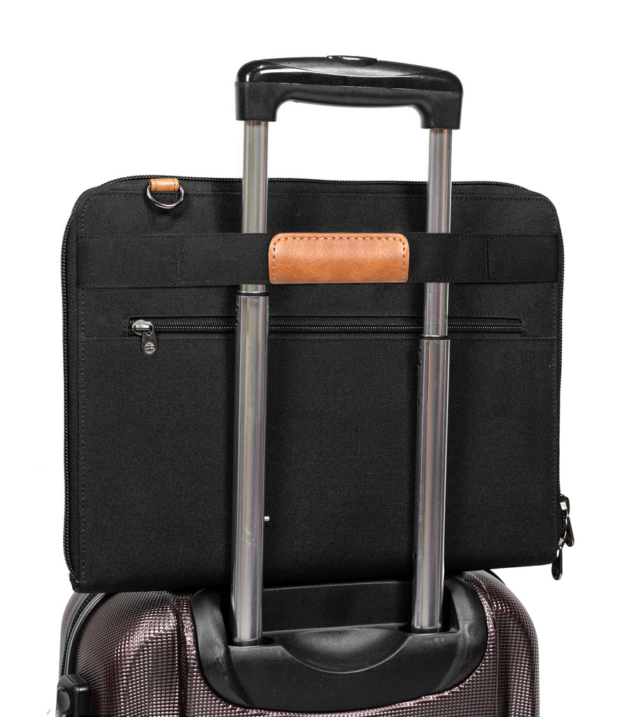 PKG Wellington 10L Messenger (black) attached to luggage handle using trolley strap