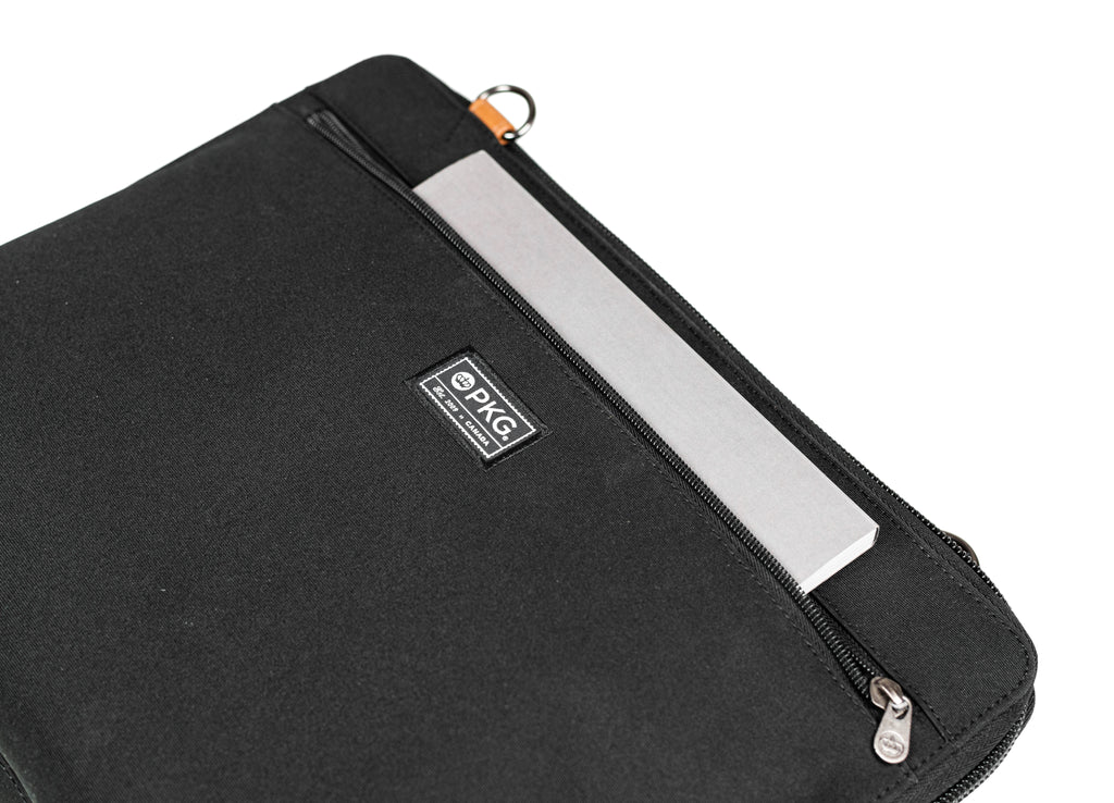 PKG Wellington 10L Messenger (black) showing notebook inserted in front pocket