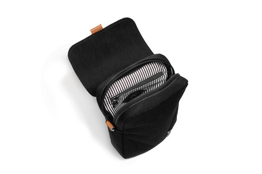 PKG Burrard recycled cross body bag (black), top open view showing inner lining and organization