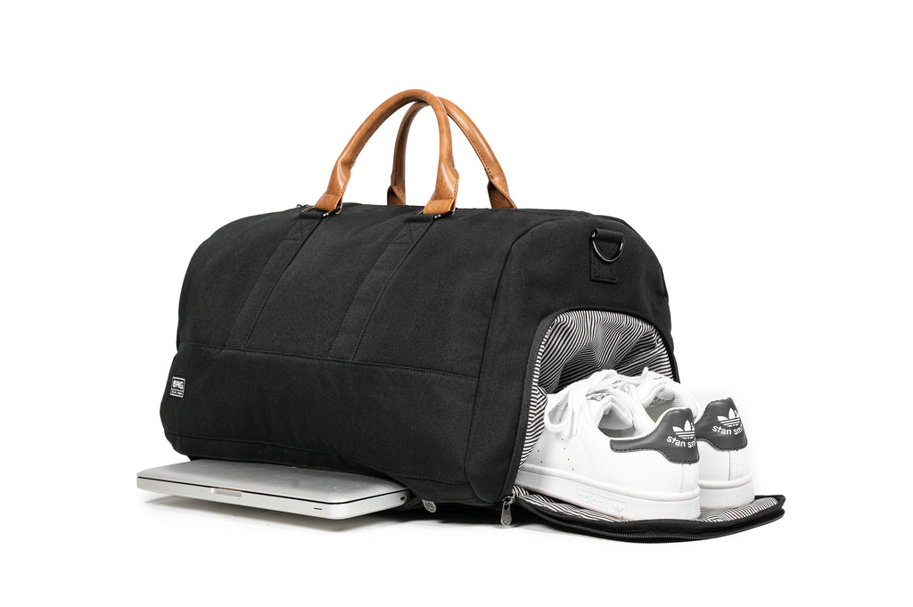 PKG Bishop 42L recycled duffle bag (black) showing both the dedicated shoe compartment and padded laptop compartment