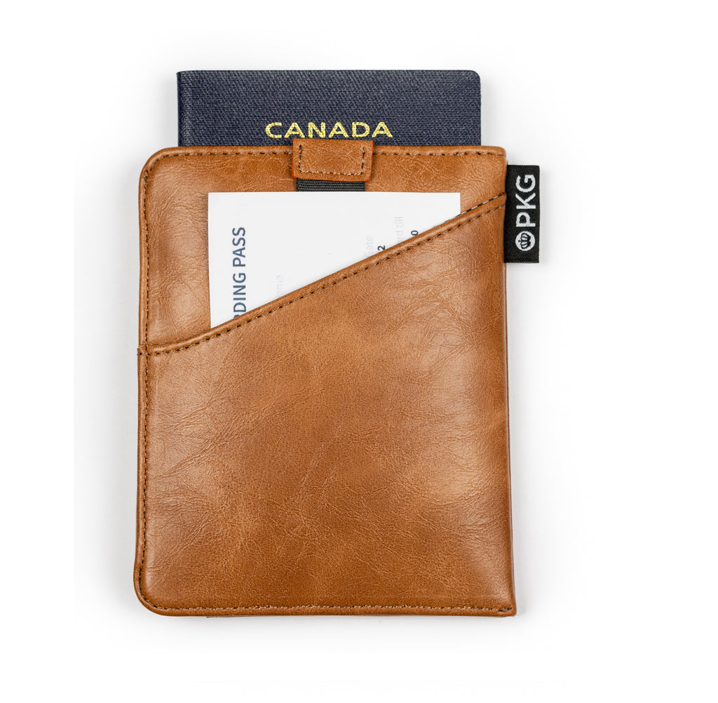 PKG Perry RFID Passport Wallet (tan) showing passport inside as well as convenient outer slot for documents such as boarding passes