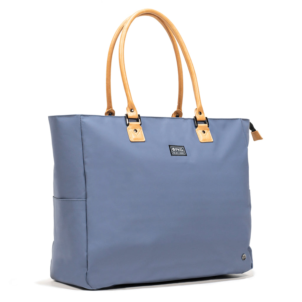PKG Georgian 33L Recycled Tote Bag (vintage blue). Weather-resistant, padded base, metal feet, and faux leather accents, this tote ensures safety, durability, and style. Ideal for overnight trips, work, and more