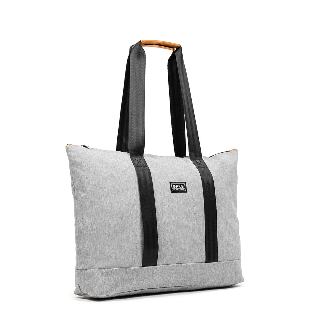 PKG Lawrence 16L Recycled Tote Bag (light grey). This mid-size tote, made from weather-resistant recycled fabrics, is your ideal everyday carry. With exterior trolley straps, it's perfect for women's purse essentials or a laptop bag