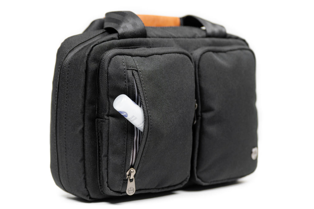 PKG Simcoe accessory bag (black) with example of small toiletry product being stored in small front pocket