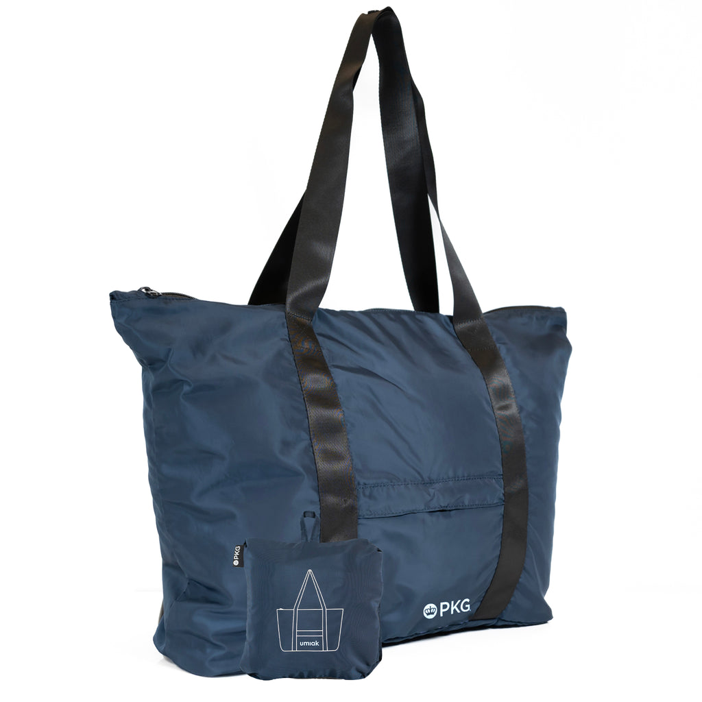PKG Umiak 33L Recycled Packable Tote (navy) – your eco-friendly EVERYDAY carry. This versatile tote, made with 100% recycled material, is antimicrobial, water-resistant, and tear-resistant. Reinforced seams add durability. Ideal for work, travel, and daily use.