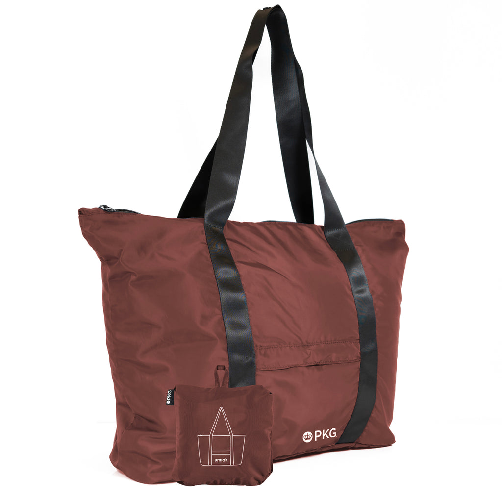 PKG Umiak 33L Recycled Packable Tote (rum raisin) – your eco-friendly EVERYDAY carry. This versatile tote, made with 100% recycled material, is antimicrobial, water-resistant, and tear-resistant. Reinforced seams add durability. Ideal for work, travel, and daily use.