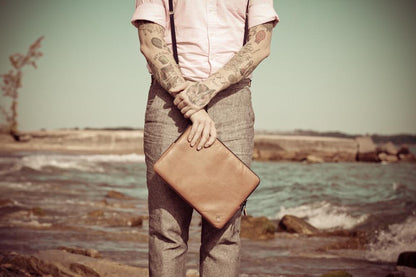 person holding PKG Skinny Leather Sleeve 15" 