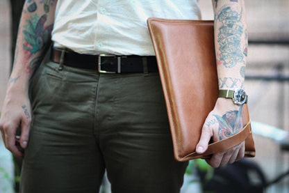 person holding PKG Slim Leather Sleeve 13" (tan)