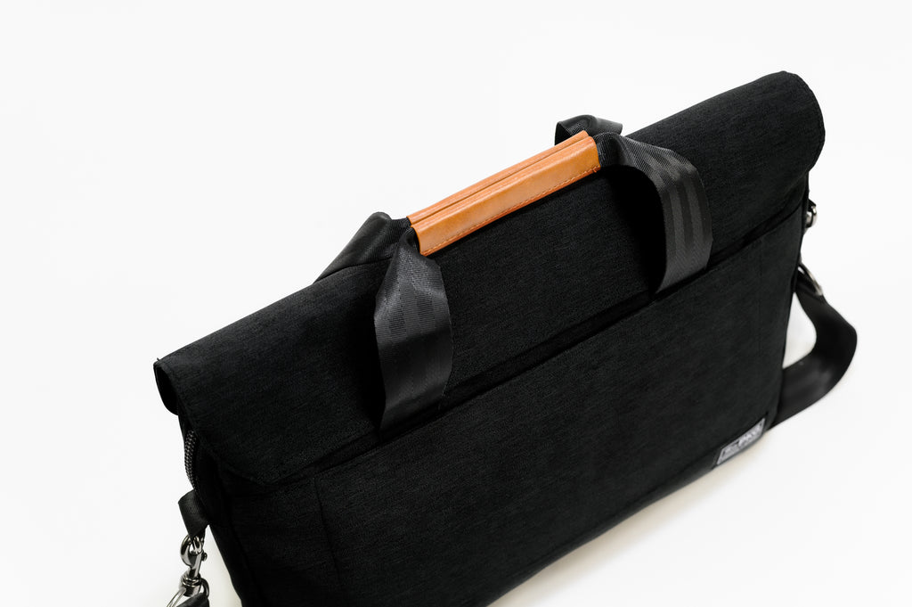 PKG Richmond 10L Messenger (black) top view showing magnetic vegan leather handles for clean aesthetic