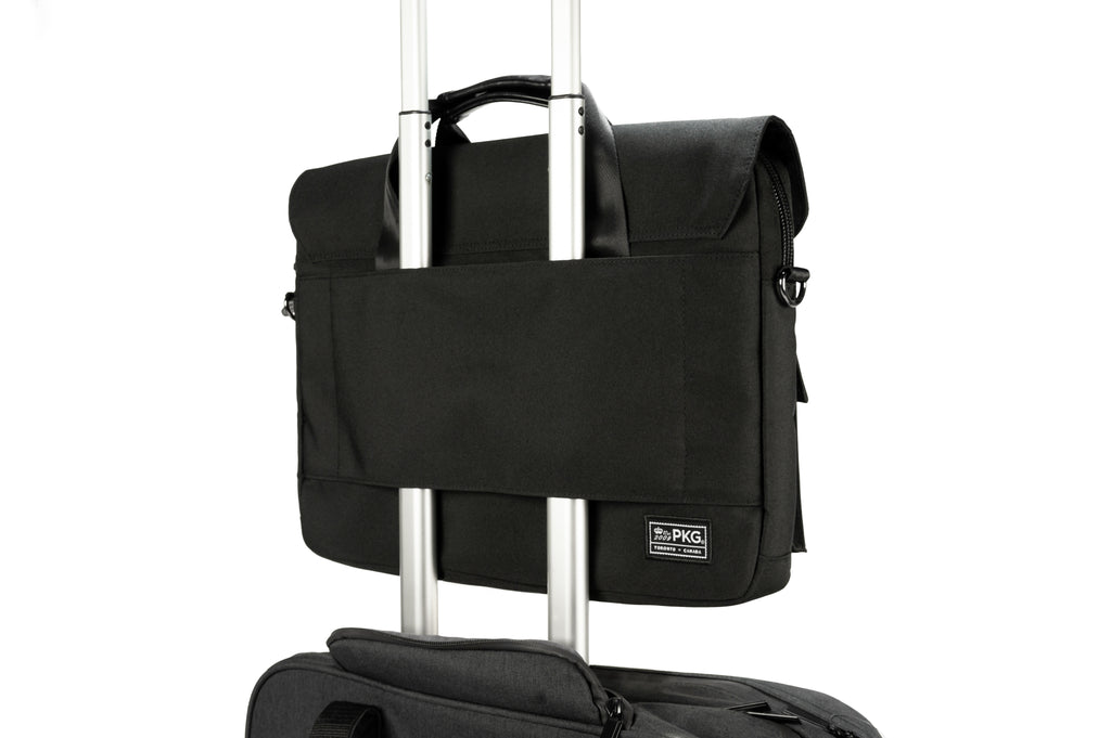 PKG Richmond 10L Messenger (black) connected to luggage using trolley strap