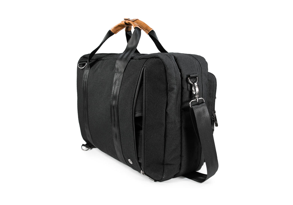 PKG Trenton 31L Messenger Bag (black) back angled view showing pocket that houses backpack style shoulder straps